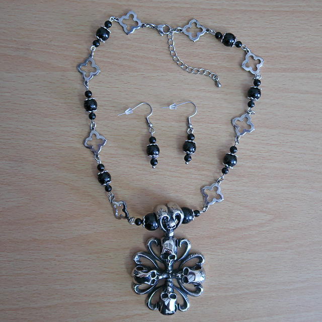 Four Skull Cross necklace and earrings (overhead view)