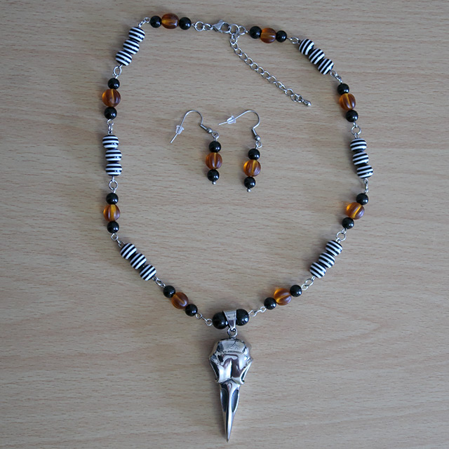 Bird/Raven Skull necklace and earrings (overhead view)